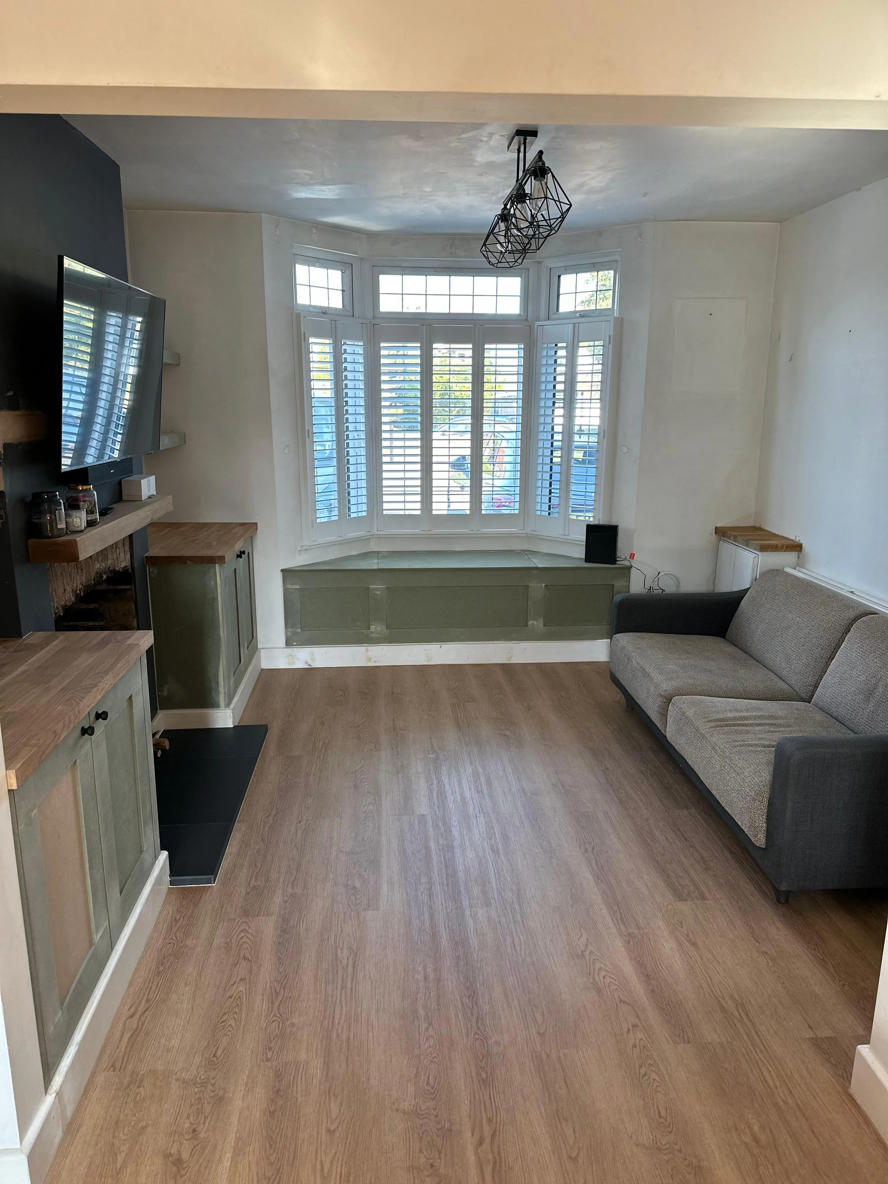 Victorian living room renovation with bay window seat and bespoke joinery